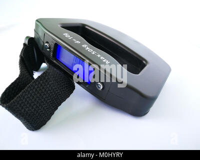 Weighing suitcase with digital scale for hand luggage on a flight Stock  Photo - Alamy