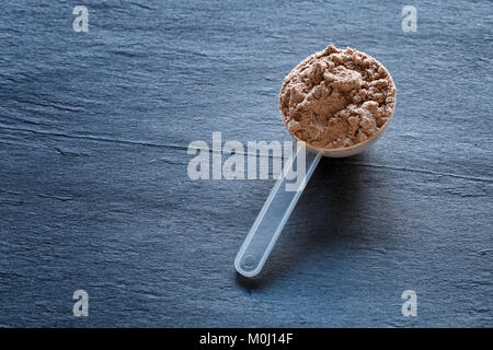 Plastic Measuring Scoop Of White Powder Whey Protein Against Grunge Wood  Background Stock Photo, Picture and Royalty Free Image. Image 13746751.