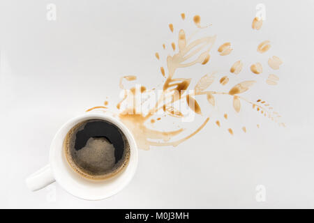 top view of cup of coffee and brown stains in floral shape on grey Stock Photo