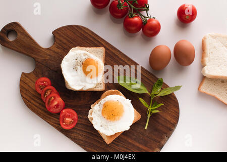 breakfast with fried eggs on toasts Stock Photo