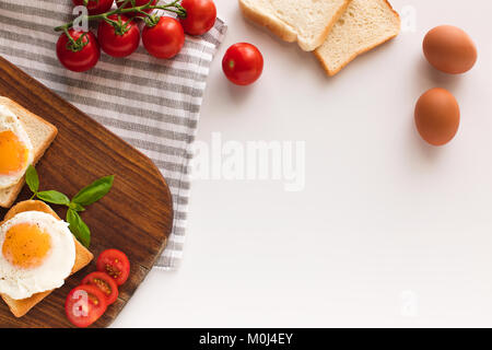 breakfast with fried eggs on toasts Stock Photo
