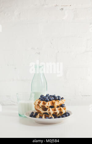 delicious breakfast of waffles with blueberries and glass of milk Stock Photo