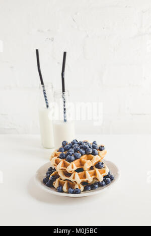 fresh breakfast of waffles with blueberries and milk Stock Photo