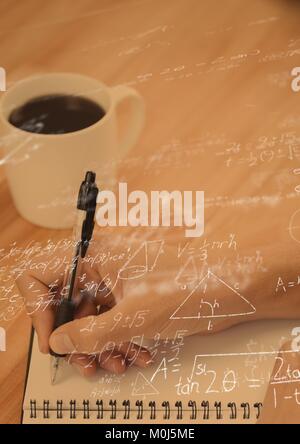 Hand writing with graph overlays Stock Photo