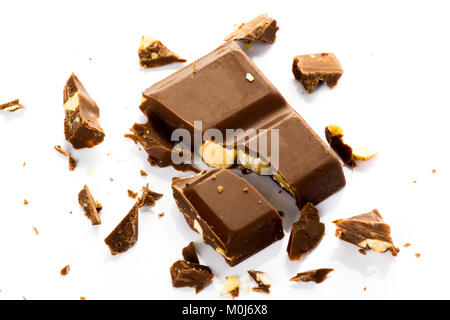 Piece of chocolate with hazelnuts set in several on a white background Stock Photo