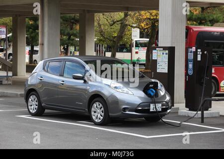NARA, JAPAN - NOVEMBER 23, 2016: Nissan Leaf electric car charging at a station in Nara, Japan. Zero-emissions vehicles have improved vastly in recent