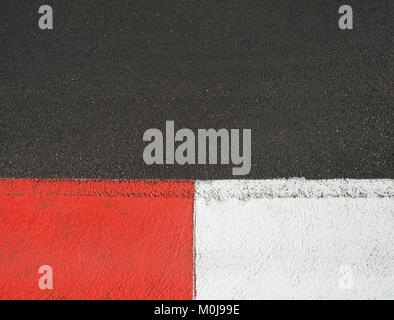 Texture of motor race asphalt and red white curb on Grand Prix street circuit Stock Photo