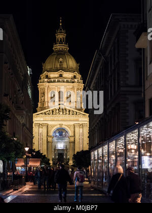 St. Stephen's Basilica illuminated at night with pedestrians on the street; Budapest, Budapest, Hungary Stock Photo