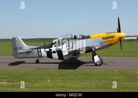 North American P-51D Mustang flown by the Old Flying Machine Company taxiing out at Duxford during a air display. Stock Photo