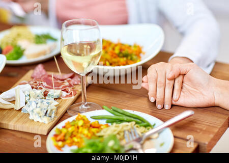 hands of people at table praying before meal Stock Photo