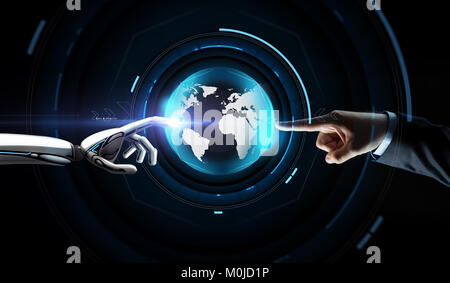 human and robot hand with virtual earth hologram Stock Photo