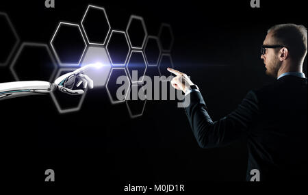 businessman and robot touching network hologram Stock Photo