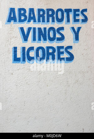 A Painted Sign On A Wall Outside A Store Selling Liquor And Wine In Santa Cruz Bay Oaxaca State, Huatulco, Mexico Stock Photo