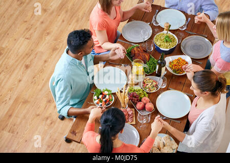 group of people at table praying before meal Stock Photo