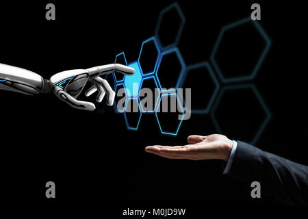 human hand and robot touching network hologram Stock Photo