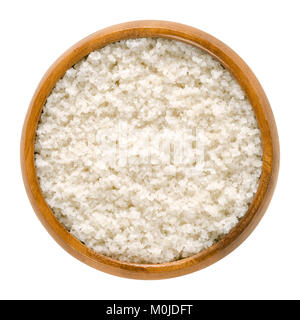 Atlantic sea salt in wooden bowl. Unrefined, unwashed, untreated, coarse salt without additives. Harvested from clay layer. Isolated macro food photo. Stock Photo