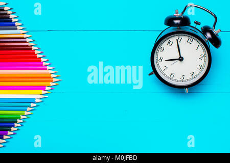 tationery and alarm clock on a blue wooden table Stock Photo