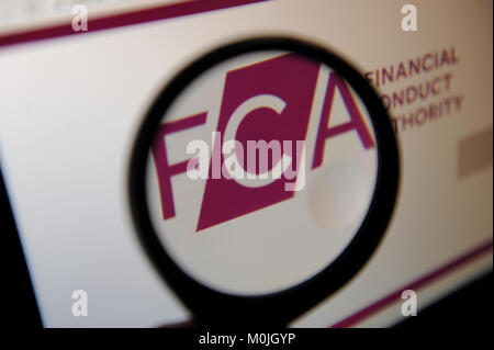 The Financial Conduct Authority website logo seen through a magnifying glass Stock Photo