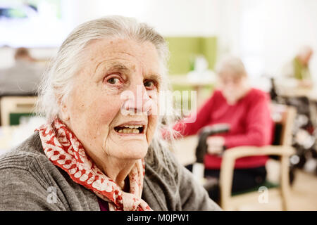 Demented senior citizen, portrait, looking questioningly, in a retirement home, Germany Stock Photo