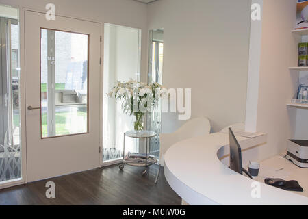 Reception area with waiting room at physiotherapy clinic. Working place - table with computer. Stock Photo