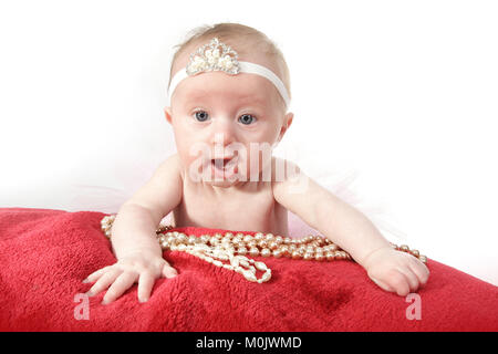 infant in pink tutu skirt, pretty little girl playing in nursery, child development Stock Photo