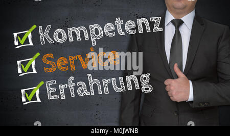 Kompetenz, Service, Erfahrung (in german Competence, service, experience) concept and businessman with thumbs up. Stock Photo
