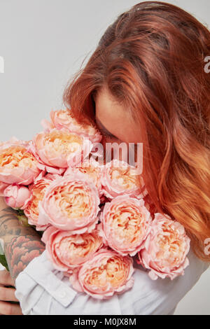 beautiful girl sniffing white rose Stock Photo - Alamy