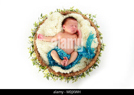 newborn baby boy sleeping in basket Stock Photo