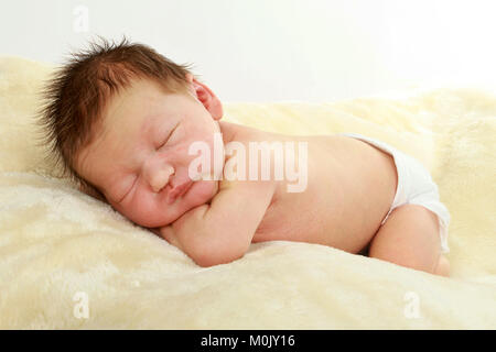 newborn baby boy sleeping on blanket Stock Photo
