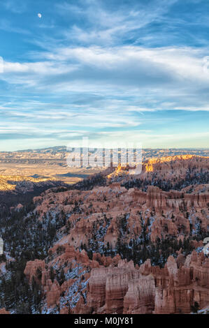 Crested moon rise over the Bryce Canyon on an early winter evening, Bryce Canyon National Park, Utah, United States. Stock Photo