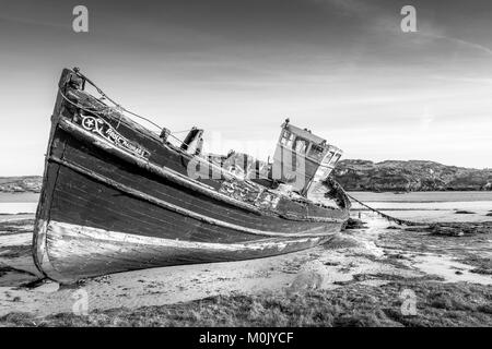 This is a photo of a wrecked fishing boat on Cruit Island on the Donegal coast in Ireland Stock Photo