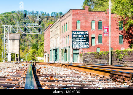 Thurmond, USA - October 19, 2017: Railroad rail junction, abandoned closed buildings with sign in West Virginia ghost town village Stock Photo