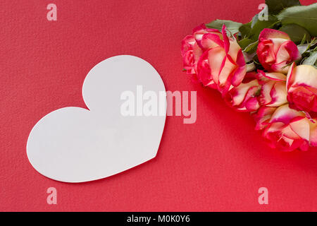 Valentines day greeting card roses red background white heart Stock Photo