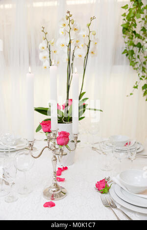 set up of a wedding table decorated with flowers Stock Photo