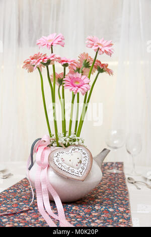 set up of a wedding table decorated with flowers Stock Photo
