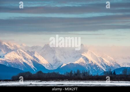 Chilkat River and Mountains in snow on a sunrise. Alaska.USA Stock Photo