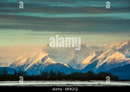 Chilkat River and Mountains in snow on a sunrise. Alaska.USA Stock Photo