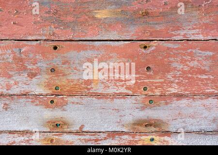 Shabby pink painted boards with small holes Stock Photo