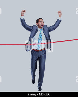 Happy businessman running through finishing line. Isolated on white Stock Photo