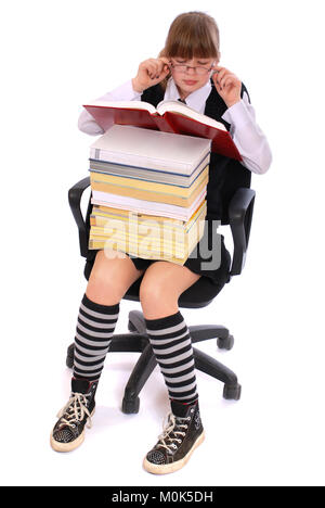 The girl has put the big pile of books on knees. On a white background. Stock Photo
