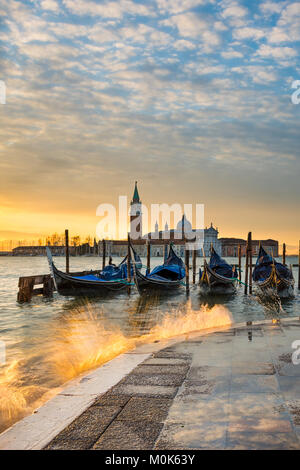 Gondolas on the Grand Canal at sunrise in Venice, Italy