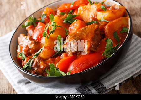 Stewed beef with vegetables in spicy sauce in a bowl on a table in Asian style. horizontal Stock Photo