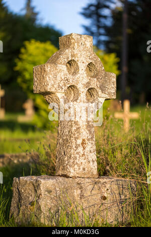 A stone tombstone in the shape of a Celtic cross at St Mary Magdalene Church; Mayne Island, British Columbia, Canada Stock Photo
