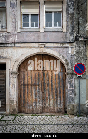 old rusty garage doors on a cobbled street. Stock Photo