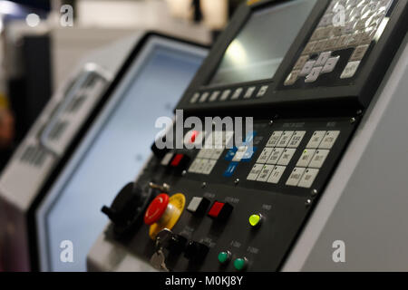 CNC metalworking machine with the control panel in the foreground. Selective focus. Stock Photo