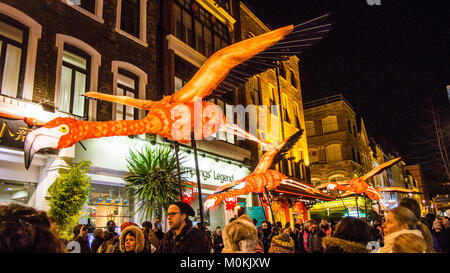 'Flying' Flamingo's operated by puppeteers in Chinatown during the 'Lumiere' Light Festival, London. Stock Photo