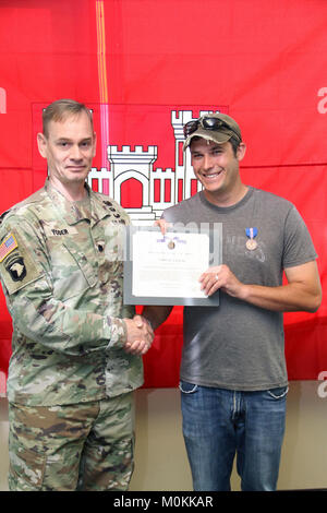 U.S. Army Corps of Engineers St. Paul District public affairs specialist Patrick Loch received the Army's Achievement Medal for Civilian Service from Recovery Field Office (RFO) commander Lt. Col. Andrew P. Yoder on January 17, 2018. Loch was recognized for his work during federal response and recovery efforts in Puerto Rico following hurricanes Maria and Irma.    Loch was assigned to the Guaynabo, Puerto Rico-based RFO from November 20, 2017 to January 18, 2018. During his deployment, he displayed exemplary skills and resourcefulness in collecting and disseminating information, Stock Photo