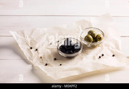 Green and black pickled olives on a white background Stock Photo