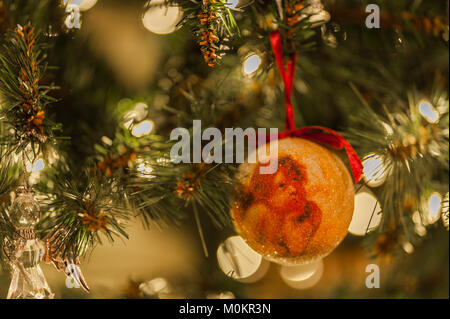 Christmas decoration on a Christmas tree with lights and copy space. Stock Photo