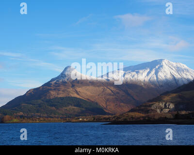 The pap of Glencoe (Sgorr na Ciche) viewed across Loch Leven and Glencoe Village. Stock Photo